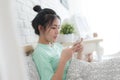 Young Asian woman taking selfie photo in bedroom