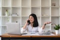 Young asian woman talking on mobile phone in office. Smiling businesswoman making a phone call. Royalty Free Stock Photo