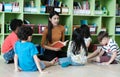 Young asian woman teacher teaching kids in kindergarten classroom, preschool education concept