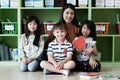 Young asian woman teacher teaching kids in kindergarten classroom, preschool education concept Royalty Free Stock Photo