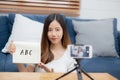 Young asian woman is teacher teaching language english with student for e-learning online at home. Royalty Free Stock Photo