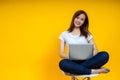 Young Asian woman teen smiling sitting on chair wearing t-shirt using laptop computer Royalty Free Stock Photo