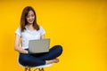 Young Asian woman teen smiling sitting on chair wearing t-shirt using laptop computer Royalty Free Stock Photo