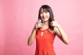 Young Asian woman thumbs up with a glass of drinking water Royalty Free Stock Photo