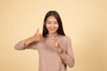 Young Asian woman thumbs up with a glass of drinking water Royalty Free Stock Photo