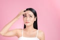 Young Asian woman touch and worry about her face. Acne, pimple, clear and clean, oily, dry skin concept Royalty Free Stock Photo