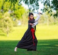 Young asian woman in traditional kimono trains fighting techniques with katana sword samurai warrior girl