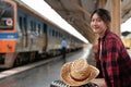 young asian woman traveler backpack waiting railway at train station, Summer holiday and travel concept Royalty Free Stock Photo