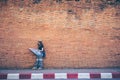 Young asian woman traveler with hat and bag looking map at Tha P Royalty Free Stock Photo