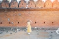 Young asian woman traveler in Yellow dress with hat and bag traveling on Tha Pae Gate, Tourist visit at the old city in Chang Mai Royalty Free Stock Photo