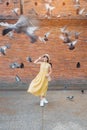 Young asian woman traveler in Yellow dress with hat and bag traveling on Tha Pae Gate, Tourist visit at the old city in Chang Mai Royalty Free Stock Photo