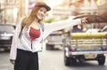 Young asian woman traveling backpacker hailing taxi on street at Yaowarat road outdoor market in Bangkok, Thailand Chinatown