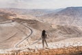 Young Asian woman traveller standing and looking to mountain road and canyon landscape of Jodan plateau, Jodan, Arab