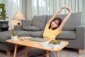 Young asian woman tried to lying stretching after working with laptop computer on couch Royalty Free Stock Photo
