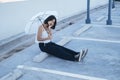 Young asian woman with umbrella at parking lot Royalty Free Stock Photo