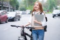 Young Asian woman using bicycle as a means of transportation