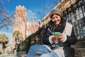 Young asian woman using a cellphone app for texting messages in a social media. Cheerful chinese girl smiling sitting Royalty Free Stock Photo