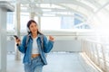 Young asian woman using headphone for listening nice music and walking in city Royalty Free Stock Photo