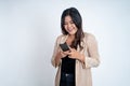 Young asian woman using mobile cell phone typing sms message Royalty Free Stock Photo