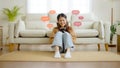 Young asian woman using mobile smartphone in living room Royalty Free Stock Photo