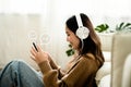 Young asian woman using mobile smartphone in living room Royalty Free Stock Photo