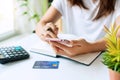 Young Asian woman using smart phone while sitting in the living room at home, close up Royalty Free Stock Photo