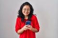 Young asian woman using smartphone typing message celebrating crazy and amazed for success with open eyes screaming excited Royalty Free Stock Photo