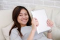 Young asian woman using tablet while sitting in sofa background, people and technology, lifestyle, adult online education, working