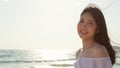 Young Asian woman walking on beach. Beautiful female happy relax walking on beach near sea when sunset in evening. Lifestyle women Royalty Free Stock Photo