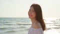 Young Asian woman walking on beach. Beautiful female happy relax walking on beach near sea when sunset in evening. Lifestyle women Royalty Free Stock Photo