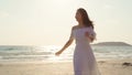 Young Asian woman walking on beach. Beautiful female happy relax walking on beach near sea when sunset in evening. Lifestyle women Royalty Free Stock Photo