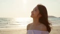 Young Asian woman walking on beach. Beautiful female happy relax walking on beach near sea when sunset in evening. Lifestyle women Royalty Free Stock Photo