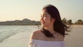 Young Asian woman walking on beach. Beautiful female happy relax walking on beach near sea when sunset in evening. Lifestyle women Royalty Free Stock Photo