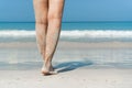 Young Asian woman walking on sand beach. Closeup detail of female feet and white sand at Phuket, Thailand. Beach travel concept Royalty Free Stock Photo