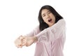 Young asian woman wear pink pajamas yawn and stretch when her wake up feeling sleepy