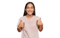 Young asian woman wearing casual clothes success sign doing positive gesture with hand, thumbs up smiling and happy Royalty Free Stock Photo