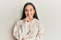 Young asian woman wearing casual sweatshirt smiling looking confident at the camera with crossed arms and hand on chin Royalty Free Stock Photo