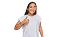 Young asian woman wearing casual white t shirt doing happy thumbs up gesture with hand Royalty Free Stock Photo