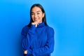 Young asian woman wearing casual winter sweater looking confident at the camera smiling with crossed arms and hand raised on chin Royalty Free Stock Photo