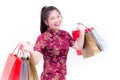 Young asian woman wearing chinese dress traditional cheongsam with Carrying a shopping bag and smile. Royalty Free Stock Photo