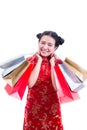 Young asian woman wearing chinese dress traditional cheongsam with Carrying a shopping bag and smile. Royalty Free Stock Photo