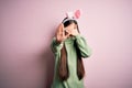 Young asian woman wearing cute easter bunny ears over pink background covering eyes with hands and doing stop gesture with sad and Royalty Free Stock Photo