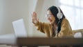 Young asian woman wearing glasses and headset working on computer laptop at house Royalty Free Stock Photo