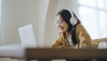 Young asian woman wearing glasses and headset working on computer laptop at house Royalty Free Stock Photo