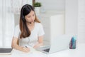 Young asian woman wearing headphone study online with e-learning on desk, girl wearing headset learning to internet with laptop. Royalty Free Stock Photo