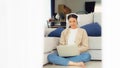 Young asian woman wearing headset in good spirits working on laptop at home Royalty Free Stock Photo