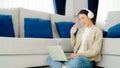 Young asian woman wearing headset while working on computer laptop at house Royalty Free Stock Photo