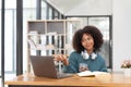 Young asian woman wearing headset working on computer laptop at house. Work at home, Video conference, Video call Royalty Free Stock Photo