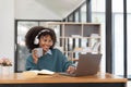 Young asian woman wearing headset working on computer laptop at house. Work at home, Video conference, Video call Royalty Free Stock Photo