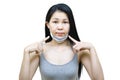 Young asian woman wearing medical face mask her hand point at pimple on chin,Skin allergy,acne from wearing a mask